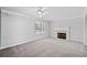 Bright living room showcasing plush carpeting, a fireplace, and neutral paint at 3313 Summit Creek Ln, Loganville, GA 30052