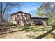 The backyard of a two-story home with a deck and mature trees at 446 Martindale Ct, Stone Mountain, GA 30088