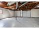 Unfinished basement with open ceiling and two garage doors at 446 Martindale Ct, Stone Mountain, GA 30088