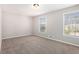 Inviting bedroom with plush carpeting, neutral paint, and two windows for abundant natural light at 446 Martindale Ct, Stone Mountain, GA 30088