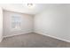 Cozy bedroom with plush carpeting, neutral paint, and a large window providing natural light at 446 Martindale Ct, Stone Mountain, GA 30088