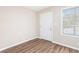 Bright bedroom featuring wood-look flooring, neutral paint, ample natural light, and a door at 446 Martindale Ct, Stone Mountain, GA 30088