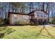 Two-story home featuring a brick facade, updated windows, attached garage, and lush green lawn at 446 Martindale Ct, Stone Mountain, GA 30088