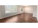 Spacious living room featuring wood-look flooring, neutral paint, and large windows for ample light at 446 Martindale Ct, Stone Mountain, GA 30088