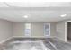 Unfinished basement with concrete floors, two windows, and white ceiling tiles at 6405 Grafton Dr, Austell, GA 30168