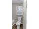 Bathroom showcasing a window, toilet, and tub at 6405 Grafton Dr, Austell, GA 30168