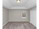 Spacious bedroom with tray ceiling, plush carpet, and natural light from the window at 6405 Grafton Dr, Austell, GA 30168