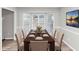A dining room with dining table, six chairs, bay windows, and a painting on the wall at 6405 Grafton Dr, Austell, GA 30168