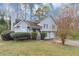 Inviting two-story home with light gray siding, a covered front porch, and mature landscaping at 6405 Grafton Dr, Austell, GA 30168