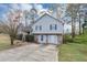 Attractive two-story home boasting light gray siding, dark shutters, and stone veneer on the lower level at 6405 Grafton Dr, Austell, GA 30168