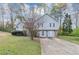 Charming two-story home featuring light gray siding, stone accents, and a well-manicured front lawn at 6405 Grafton Dr, Austell, GA 30168