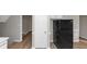 A kitchen featuring a refrigerator, white cabinets and an adjacent doorway at 6405 Grafton Dr, Austell, GA 30168