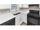 Close-up of a kitchen featuring modern black appliances and white cabinets at 6405 Grafton Dr, Austell, GA 30168