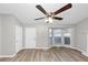 Bright living room with wood-look floors, a bay window, and a white front door with hardware at 6405 Grafton Dr, Austell, GA 30168