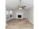 Living room featuring wood-look floors, a modern ceiling fan, and a fireplace with white mantle at 6405 Grafton Dr, Austell, GA 30168