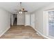 An open-plan living room featuring wood floors, a ceiling fan and a stairway at 6405 Grafton Dr, Austell, GA 30168