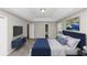 Comfortable main bedroom with a blue bed, large TV, and a view to the en-suite bathroom at 6405 Grafton Dr, Austell, GA 30168