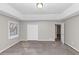 Bright main bedroom featuring neutral walls, tray ceiling, and plush carpet and closet space at 6405 Grafton Dr, Austell, GA 30168