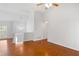 Bright, airy living room with hardwood floors, pendant lighting, and a window at 7806 Poppy Seed Pl, Winston, GA 30187