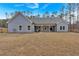 Expansive backyard with a covered patio, offering endless possibilities for outdoor living and recreation at 2317 Pleasant Grove Rd, Temple, GA 30179