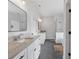 Spacious bathroom featuring double vanities, granite countertops, tile floors, and a glass enclosed shower at 2317 Pleasant Grove Rd, Temple, GA 30179