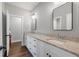 This bathroom features a granite countertop, white cabinets, and double sinks at 2317 Pleasant Grove Rd, Temple, GA 30179