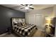 This bedroom has carpet, a ceiling fan, one window, and a bed with a plaid blanket at 2317 Pleasant Grove Rd, Temple, GA 30179