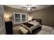 This bedroom features carpet, a window, ceiling fan, bed, white bench and sofa at 2317 Pleasant Grove Rd, Temple, GA 30179