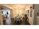 Elegant dining room with modern chandelier, wainscoting, and ample natural light, showcasing a stylish interior at 2317 Pleasant Grove Rd, Temple, GA 30179