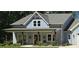 Close up shot of a charming light-blue farmhouse with a welcoming front porch and rustic decor at 2317 Pleasant Grove Rd, Temple, GA 30179
