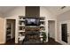Living room fireplace featuring built-in shelving, a stone hearth, and a mounted television at 2317 Pleasant Grove Rd, Temple, GA 30179
