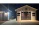 This garage features lights above the closed brown garage door at 2317 Pleasant Grove Rd, Temple, GA 30179