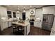 Stylish kitchen featuring white cabinets, granite countertops, stainless steel appliances, and an island with seating at 2317 Pleasant Grove Rd, Temple, GA 30179
