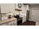 Modern kitchen showcasing white cabinets, subway tile, stainless steel appliances, and wooden accents, creating a cozy atmosphere at 2317 Pleasant Grove Rd, Temple, GA 30179