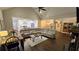 Open-concept living room with vaulted ceilings, a large sectional, and views into the modern kitchen and dining area at 2317 Pleasant Grove Rd, Temple, GA 30179