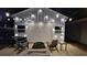 Inviting outdoor space featuring a covered patio with string lights and comfortable seating around a fire pit at 2317 Pleasant Grove Rd, Temple, GA 30179