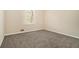 An empty bedroom featuring carpet, neutral walls, and a window at 2339 Chevy Chase Ln, Decatur, GA 30032