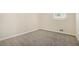 A clean bedroom with modern carpet, a window, and baseboard trim at 2339 Chevy Chase Ln, Decatur, GA 30032
