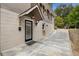 Back entrance to home featuring a covered porch, black framed window, exterior lighting and long driveway at 746 Amsterdam Ave, Atlanta, GA 30306