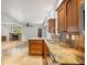 A gourmet kitchen with granite counters and updated cabinetry, adjacent to an open living area with a stone fireplace at 746 Amsterdam Ave, Atlanta, GA 30306