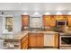 Bright kitchen featuring granite counters, custom cabinetry, stainless steel appliances, and a window view at 746 Amsterdam Ave, Atlanta, GA 30306