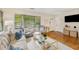 Bright living room featuring hardwood floors, neutral furniture, and a view of the front yard at 746 Amsterdam Ave, Atlanta, GA 30306