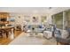 Open-concept living room with hardwood floors, neutral furniture, and access to the kitchen and dining area at 746 Amsterdam Ave, Atlanta, GA 30306