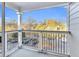 Balcony offers open-air view of parking lot surrounded by trees and bright, sunny skies at 8303 Santa Fe Pkwy, Atlanta, GA 30350