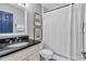 The bathroom includes a shower, vanity with granite countertop, framed art, and a stylish mirror at 8303 Santa Fe Pkwy, Atlanta, GA 30350