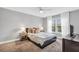 Bedroom boasts a queen-size bed, plush carpeting, a ceiling fan, and natural light from the large window at 8303 Santa Fe Pkwy, Atlanta, GA 30350