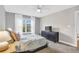 Spacious bedroom with large window, plush carpeting, and complemented by two side tables and a ceiling fan at 8303 Santa Fe Pkwy, Atlanta, GA 30350
