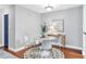 Dining area with gray walls and wood floors featuring a round table and modern white chairs at 8303 Santa Fe Pkwy, Atlanta, GA 30350