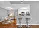 Open-concept design showcasing dining area and kitchen bar with modern stools and granite countertops at 8303 Santa Fe Pkwy, Atlanta, GA 30350