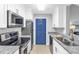 Well-lit kitchen with white cabinetry, granite countertops, and modern stainless steel appliances at 8303 Santa Fe Pkwy, Atlanta, GA 30350